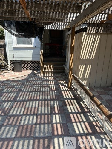 A wooden fence is in front of a house.