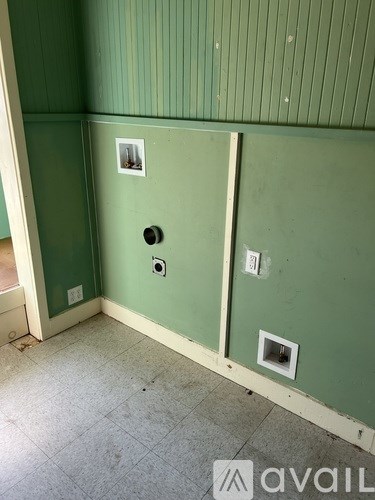 A room with green walls and a white door.