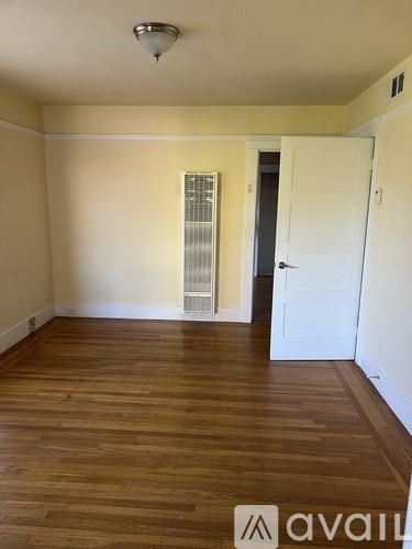 A room with wooden floors and white walls.