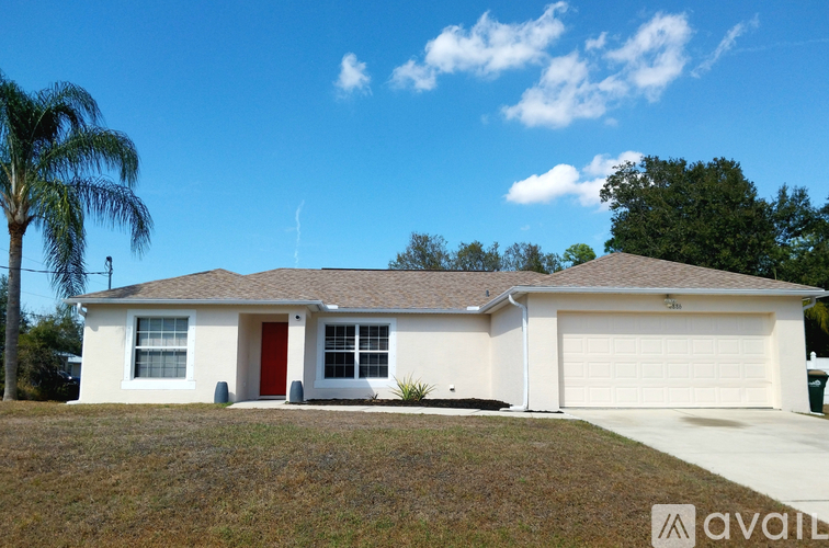 A house with a brown roof and a white garage door.