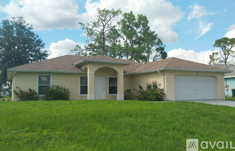 A house with a brown roof and a white garage door.