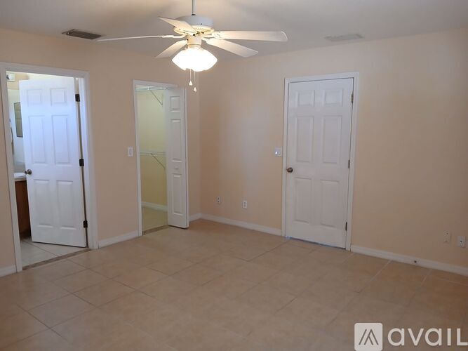 A kitchen with white cabinets and a white island with a countertop.
