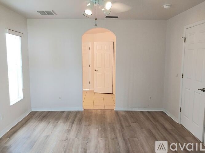 A room with a wooden floor and a white door.