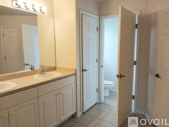 A bathroom with a sink, mirror, and toilet.