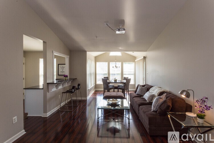 A living room with a couch, chairs, and a coffee table.