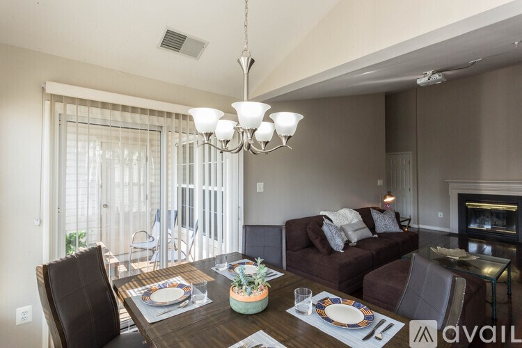 A dining room with a table set for a meal.