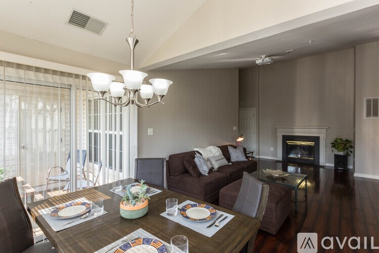 A dining room with a table set for a meal.