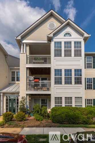 A two-story building with a balcony on the second floor.
