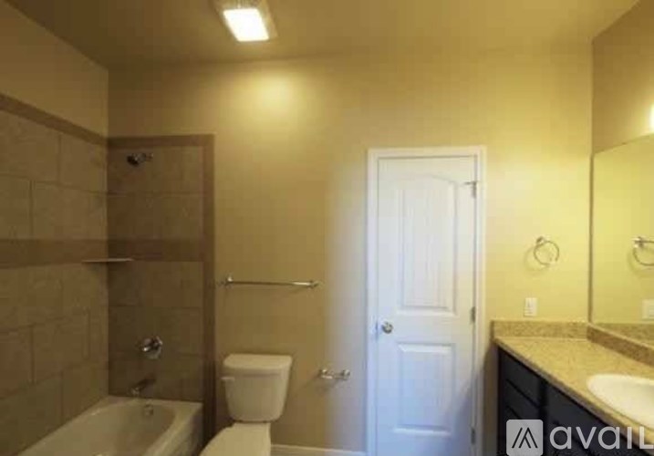 A bathroom with a toilet, sink, and bathtub.