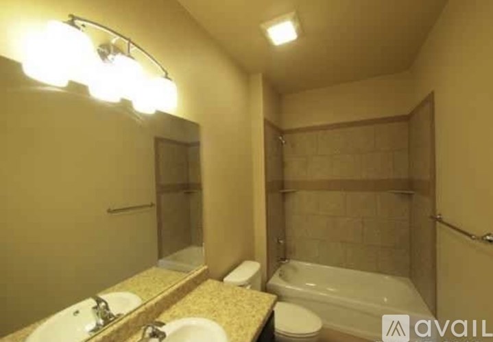 A bathroom with a sink, toilet, and bathtub.