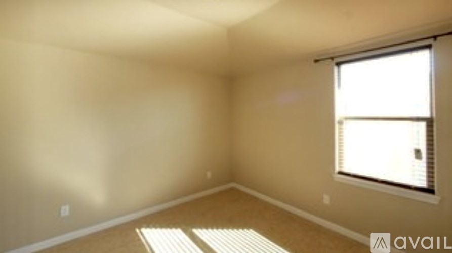 A room with a window and a mat on the floor.