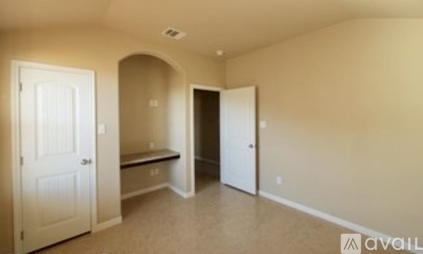 A room with a bench and two doors.