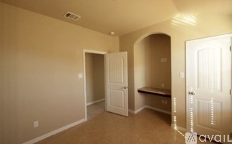 A room with a bench and a door.