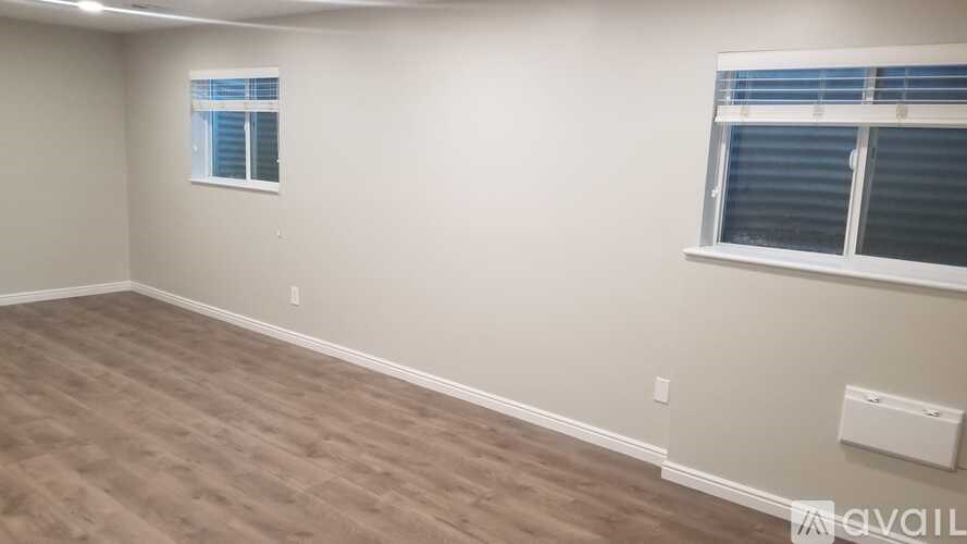 A room with a window and a wall-mounted heater.