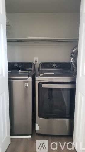 A kitchen with a stainless steel dishwasher and oven.