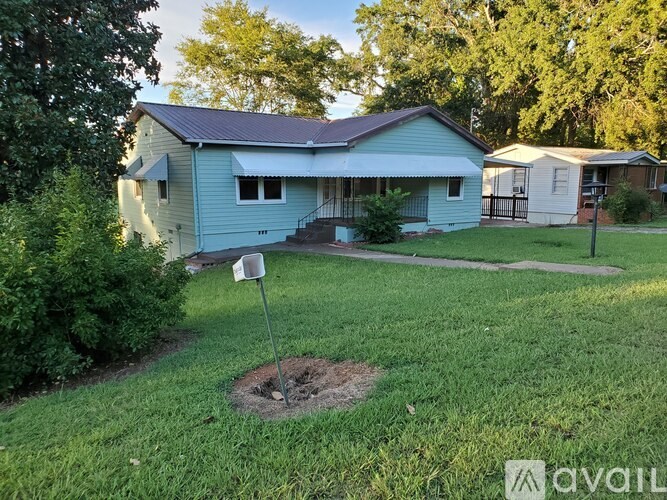 A blue house with a mailbox in front of it.