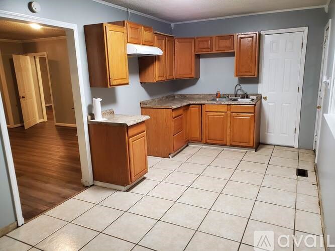 A kitchen with wooden cabinets and a white countertop.