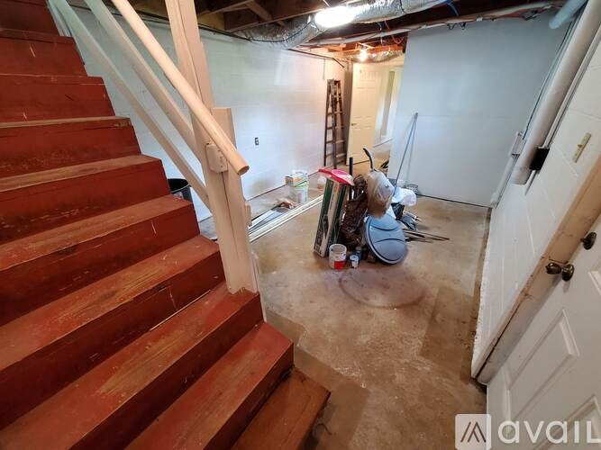 A room with a staircase and a ladder in it.