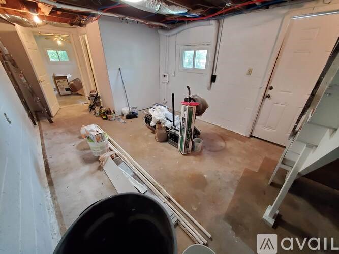 A room with a lot of construction materials and tools scattered around.