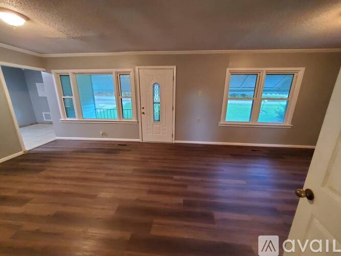 A room with wooden floors and a white door.