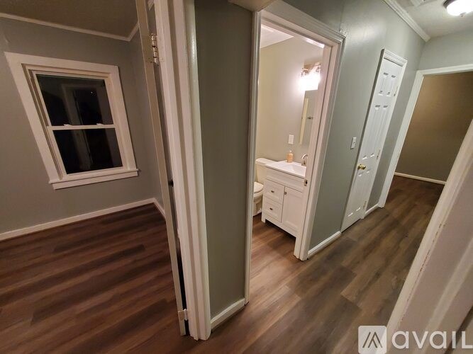 A room with a wooden floor and a white door.