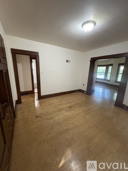 A room with wooden floors and white walls.