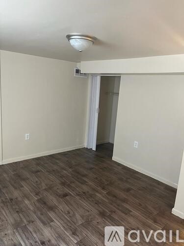 A room with wooden flooring and a white ceiling.