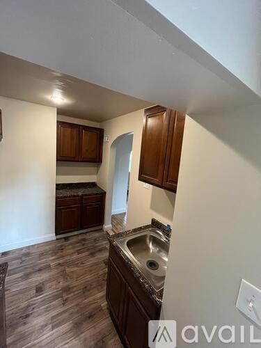 A kitchen with wooden cabinets and a sink.