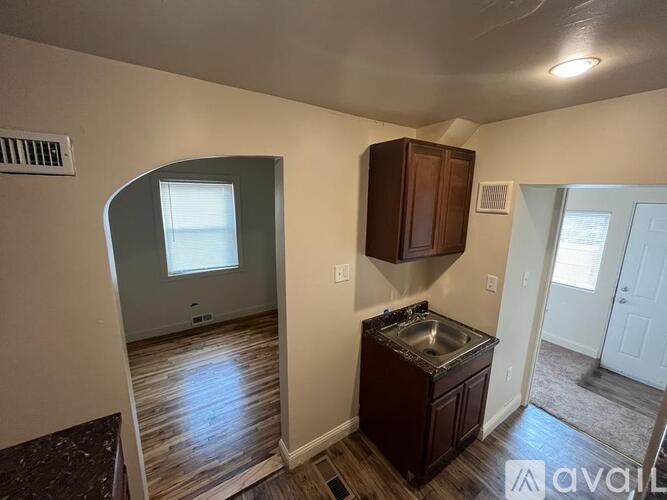 A kitchen area with a sink and cabinets.