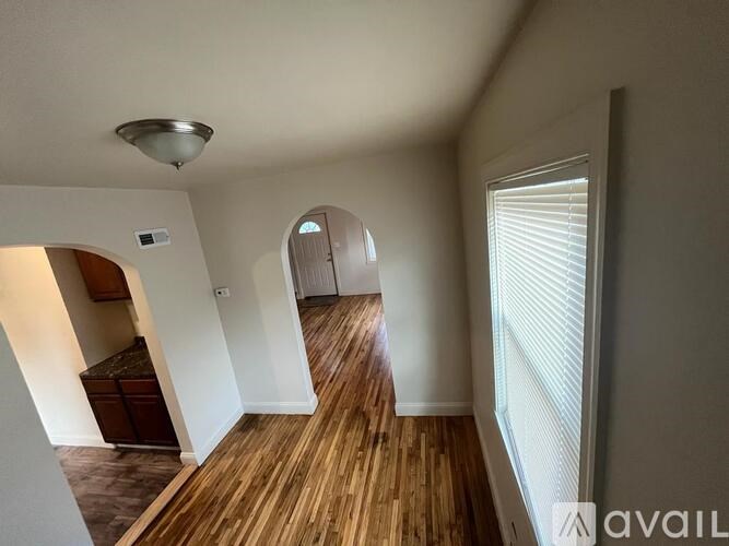 A room with wooden floors and white walls.