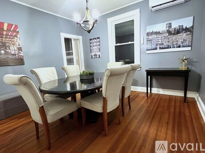 A dining room with a table and chairs.