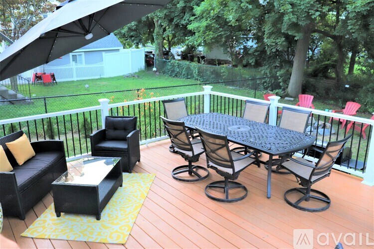 A patio with a black table and chairs.