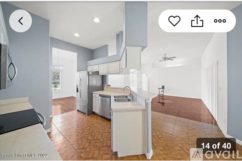A modern kitchen with a refrigerator, dishwasher, and stove top.