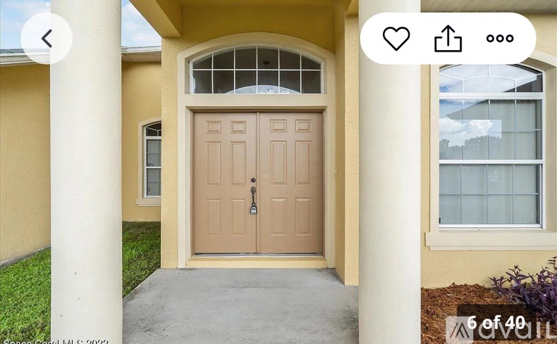 A beige door with a glass window above it.