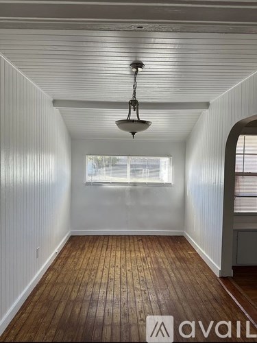 A room with wooden floors and white walls.