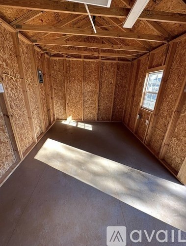 A room under construction with wooden walls and ceiling.