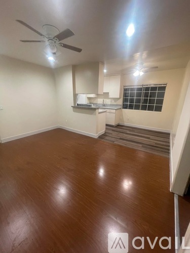 A room with wooden flooring and a ceiling fan.