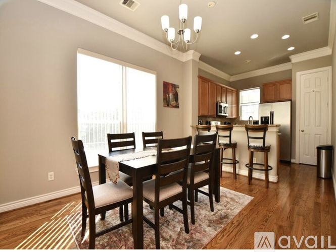 A dining room with a table set for four.