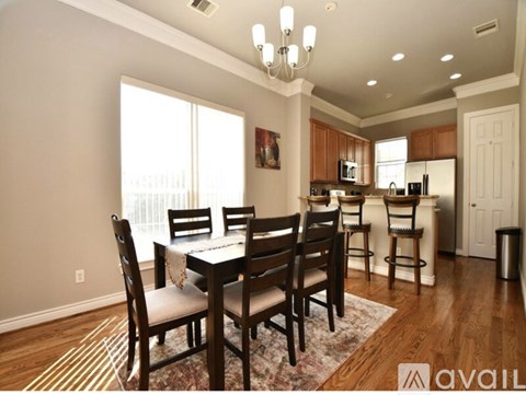 A dining room with a table set for four.