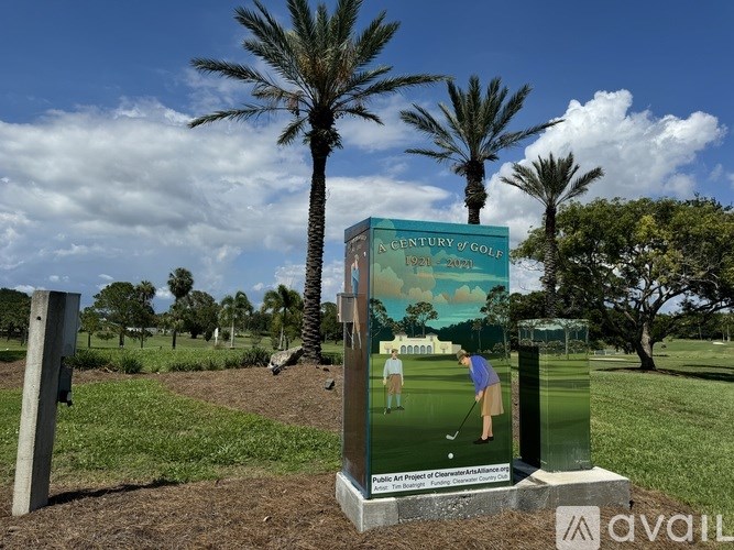 A sign in front of palm trees advertises a Century of Golf course.