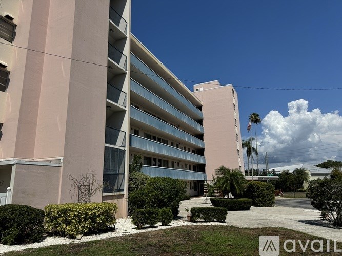 A modern building with a clear blue sky above it.