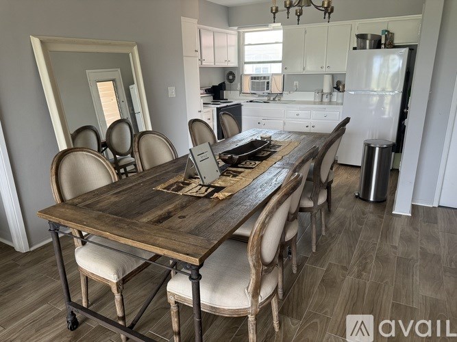 A kitchen with a dining table and chairs.