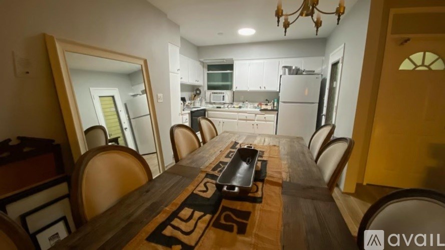 A dining room with a long table and chairs.