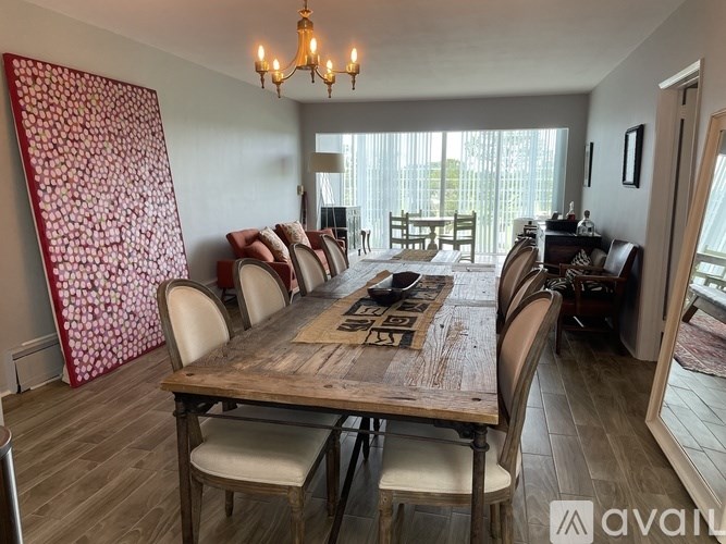 A dining room with a wooden table and chairs.