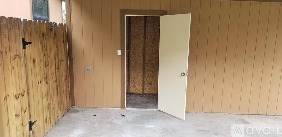 A room with a wooden fence and a door.