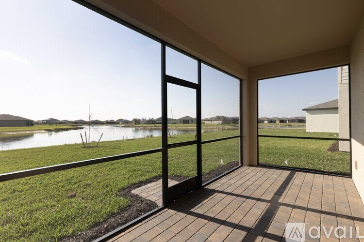 A patio with a view of a lake and houses.