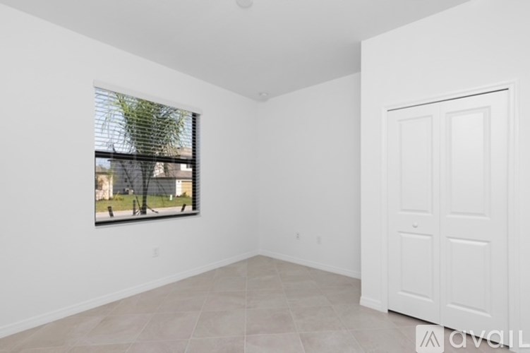 A white room with a window and a door.