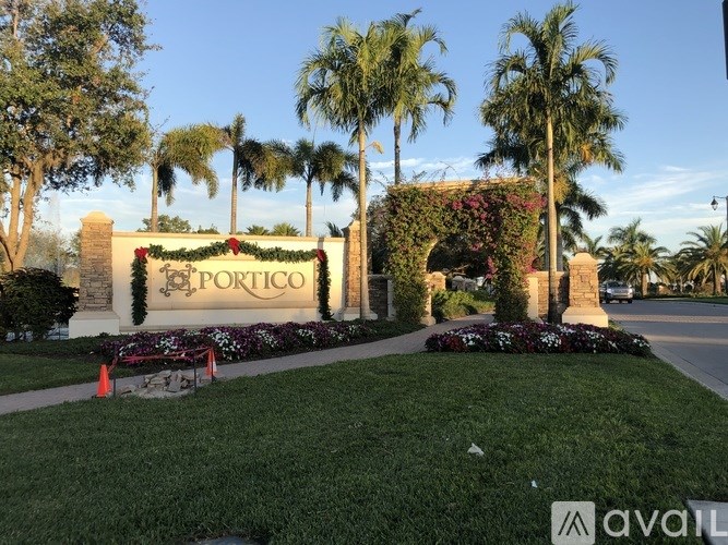 The entrance to a place called Portico is decorated with greenery and flowers.