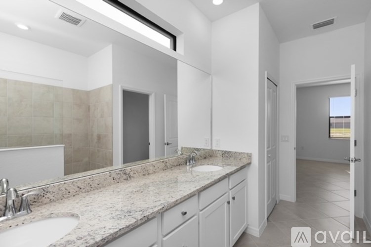 A bathroom with a sink, mirror, and cabinets.