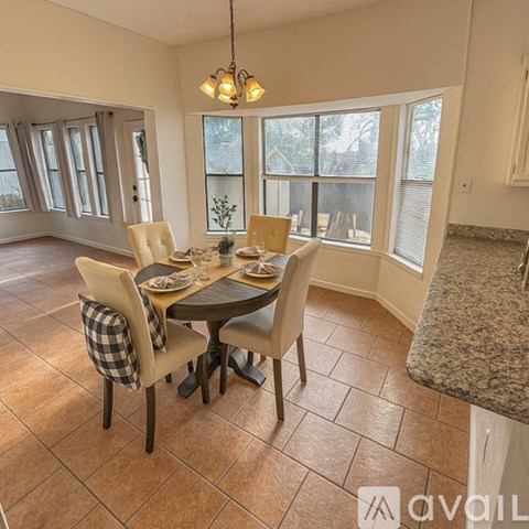 A dining room with a table set for four.